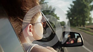 Wind Blowing Through Girl's Hair In a car. Sunset