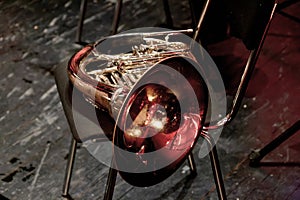 wind brass musical instrument horn lies on a chair in the theater