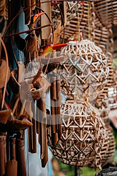 Wind chime made of bamboo with other natural handmade crafts hanging at the stall in Malaysia