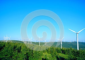 Wind driven generators on the top of mountain with blue sky