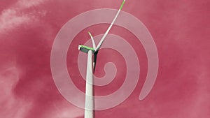 Wind Energy Dreams.Wind generator in pink clouds. Wind power through rose-colored glasses.Alternative green energy