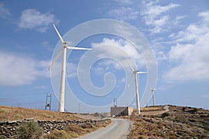 Wind-energy park wind generators blue sky and clouds  in andros island greece