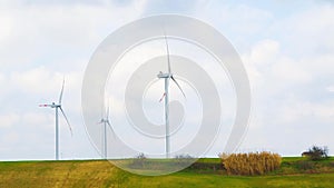 Wind energy turbines are one of the cleanest, renewable electric energy source, under blue sky with white clouds