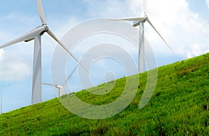 Wind energy. Wind power. Sustainable, renewable energy. Wind turbines generate electricity. Windmill farm with blue sky. Renewable