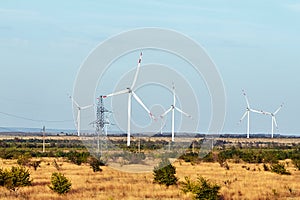 Wind energy. Wind power. Sustainable, renewable energy. Wind turbines generate electricity. Windmill farm on mountain