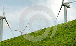 Wind energy. Wind power. Sustainable, renewable energy. Wind turbines generate electricity. Windmill farm on a mountain with blue