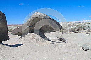 Wind-eroded rock formations of gray stone in desert photo