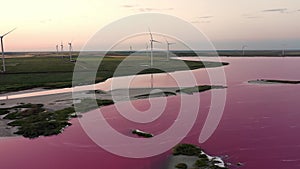 A wind farm against the backdrop of a beautiful evening golden sunset. Renewable energy production for a green