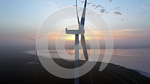 Wind farm against the backdrop of a beautiful evening golden sunset Renewable energy production for a green ecological