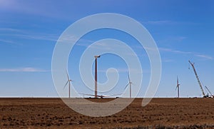 Wind farm construction building of new windmill on the wind power station installed