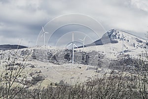 Wind farm with energy converters in a mountainous area photo