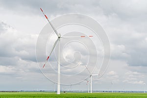 Wind farm in a green field, Wind turbines produce Green Energy
