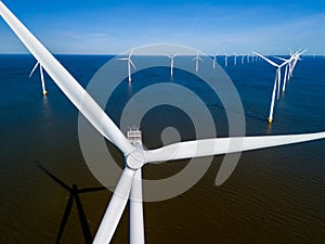A wind farm in the middle of the ocean in the Netherlands Flevoland, with windmill turbines