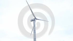 Wind farm on the mountain. Lonely windmill on a beautiful sunny day. Wind energy concept, alternative energy, renewable energy