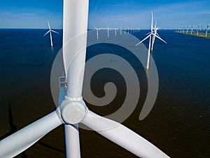 wind farm in the ocean off the coast of Flevoland, Netherlands, with rows of windmill turbines