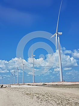 Wind farm - People in the dunes and sea - Delta do ParnaÃÂ­ba, LenÃÂ§ois Maranhenses, PiauÃÂ­, Brazil. photo