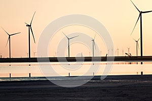 Wind farm and the salted lake Syvash at sunset light, scenic industrial and nature landscape, Kherson oblast, Ukraine