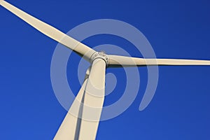 Wind farm turbines that produce electricity energy. Windmill Wind power technology productions Wind turbines standing in green fie