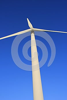 Wind farm turbines that produce electricity energy. Windmill Wind power technology productions Wind turbines standing in green fie