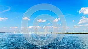 Wind Farm with Two and Three bladed Wind Turbines along the Shore of Veluwemeer photo