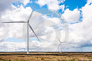 Wind farm under partly cloudy sky in spring