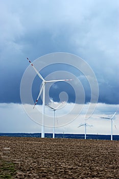 Wind farm windmill wind farm on the field against the blue sky