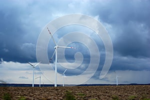 Wind farm windmill wind farm on the field against the blue sky