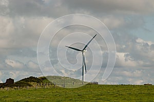 Wind farms in France - wind turbines provide electricity green energy for households in France - stormy sky