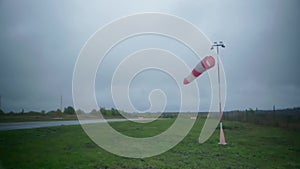 A wind flag in cloudy weather on the runway.
