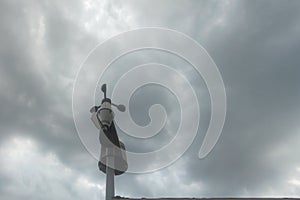 Wind gauge with storm clouds