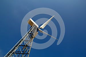 The wind generator against the blue sky photo