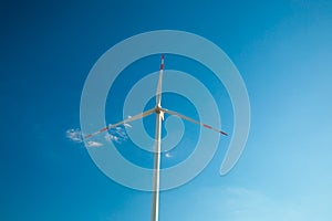 Wind generator on a blue sky background.Natural energy.Alternative natural energy source. renewable energy cost.Windmill