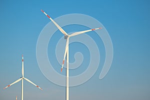 Wind generator on blue sky background.Natural energy.Windmill on sky background. renewable energy.Environmentally