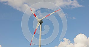 Wind generator close-up. Wind turbine against the blue sky. Rotation of wind turbine blades against the sky.