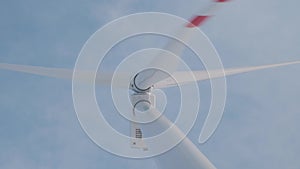 Wind generator. Gondola and blades against the blue sky.