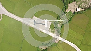 Wind generator on green agricultural field aerial view. Windmill station drone view. Renewable, sustainable, generation