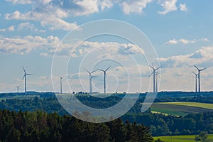 Wind generator silhouettes on the green hills.Windmill background.Green energy. renewable energy.