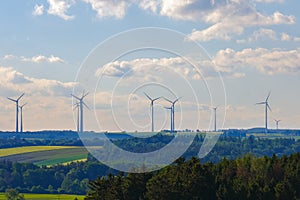 Wind generator silhouettes on the green hills.Windmill set background.Green energy. renewable energy.Environmentally