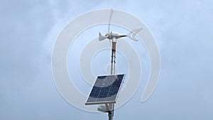 Wind generator with solar panel in windy and cloudy day