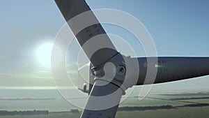 Wind generator turbine blades over countryside farm fields