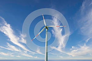 Wind generator turbine isolated on the sky background, close-up