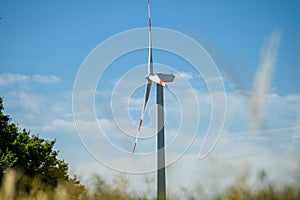 Wind generator turbine isolated on the sky background, close-up