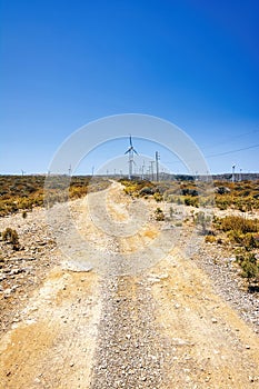 Wind generator turbines generate electricity. Wind farm on Crete island, Greece with road