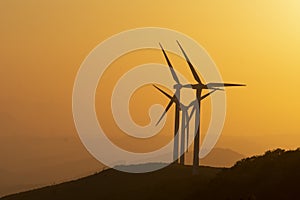 wind generators in the mountains at sunset