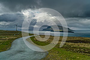 Wind generators near the road with Nolsoy Island view photo