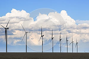 Wind Generators Silhouetted in the Evening under beautiful clouds