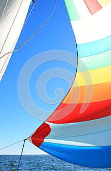 The wind has filled colorful spinnaker sail