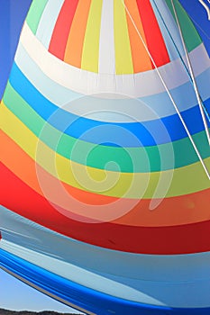 The wind has filled colorful spinnaker sail