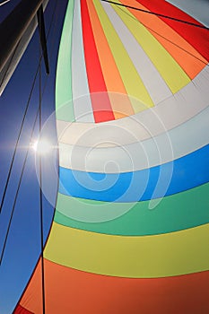 The wind has filled colorful spinnaker sail