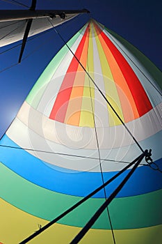 The wind has filled colorful spinnaker sail